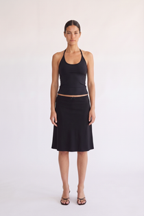 Woman wearing the Madison Skirt black scallop waist skirt, front view