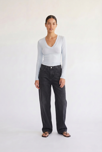 Woman wearing the Margaux baby blue deep v henley top, front view