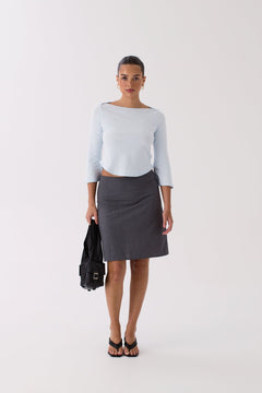 Woman wearing the Quinn grey tailored A-line skirt, front view