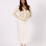 Woman wearing the Clara white knit cardigan, front view