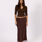 Woman wearing the Valerie brown satin lace skirt, front view
