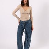 Woman wearing the Belted Wide Leg Jean blue jeans, front view