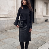 Wren Top in black — model wearing the soft knit long-sleeve top with attached draped scarf