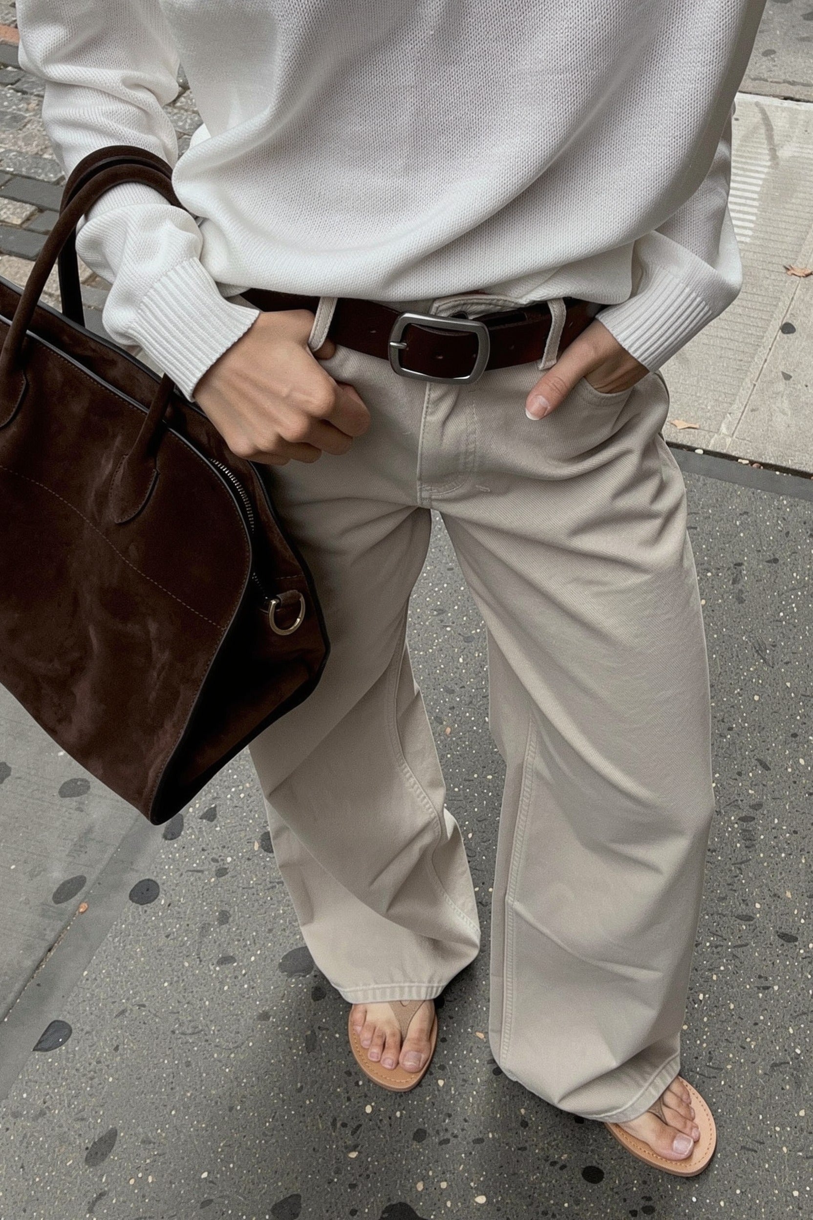 Raya Wide Belt in brown styled on the street with ecru wide leg jeans and a white knit